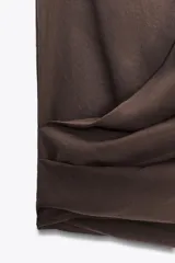 Top marrón sin mangas confeccionado en tejido fluido, con cuello halter y escote drapeado.