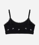 Soutien top negro de poliamida seamless texturizada con bordado de lazos blancos, breteles ajustables y copas removibles.