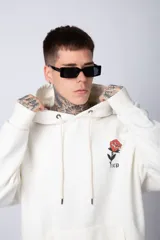 Buzo canguro negro de algodón friza, corte oversize y estampado de una rosa roja en el pecho.