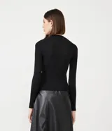 Blusa de punto negra con cuello redondo, manga larga y abertura circular en el hombro.