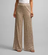 Pantalón pantalona de lentejuelas doradas con forro y cintura elástica.