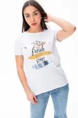 Remera blanca con estampado de pinceladas doradas, plateadas y negras, con la frase 'every day is a fresh start'.