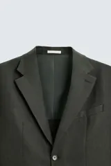 Blazer azul marino de lino con corte regular fit, cuello con solapas de muesca, manga larga con puños abotonados, bolsillo de vivo en el pecho, bolsillos de solapa en la cadera, bolsillo interior, aberturas en la espalda y cierre frontal de botonadura.