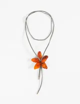 Collar con cordón verde y dije de acrílico rojo con forma de flor.