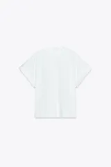Camiseta blanca de algodón con cuello redondo y mangas cortas con vuelta, trabilla y botón.