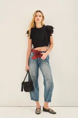 Camisa corta de voile de algodón color negro, con escote redondo y gota en la espalda. Mangas cortas con terminación de puntilla de algodón bordada.