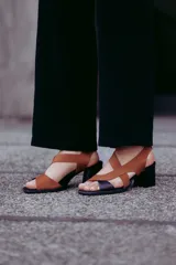 Sandalias de cuero color marrón con tiras cruzadas y taco bloque negro.