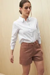 Short negro de gabardina, corte recto, con bolsillos delanteros y traseros, y presillas para cinturón.