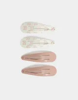Set de cuatro hebillas para el pelo tipo tic tac, dos de color rosa pálido liso y dos de color blanco con estampado de moños rosas.