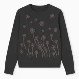 Buzo negro de punto con cuello redondo y manga larga. Presenta un estampado floral en tonos dorados y azules en el frente.