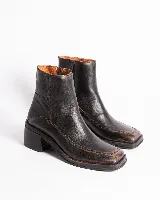 Botas cortas de cuero con estampado de piel de serpiente en tonos grises y negros. Tienen cierre lateral, punta cuadrada y taco bloque de madera color negro.