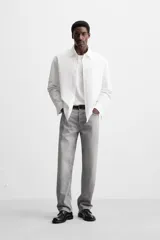 Pantalón de jean gris de corte recto, con cinco bolsillos, efecto lavado y cierre frontal con botones.