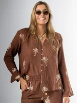 Conjunto de camisa y pantalón marrón chocolate con bordados en hilo crudo. El pantalón lleva elástico en la cintura.