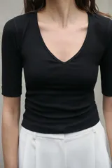 Camiseta verde oliva de algodón con escote en pico, corte slim fit y mangas tres cuartos con dobladillo.