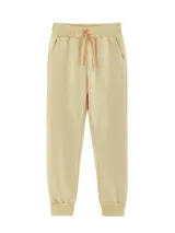 Pantalón babucha color beige, deportivo unisex, de tiro alto, con puños y cordones ajustables.
