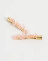 Set de dos hebillas para el pelo doradas con apliques de flores de resina color rosa y perlas.