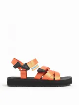 Sandalias planas con tiras de poliéster color naranja y suela negra.
