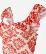 Blusa corta de tule con estampado de caracolas y peces en tonos rojo y blanco. Tiene escote cuadrado, mangas cortas con volados y fruncido en el busto.