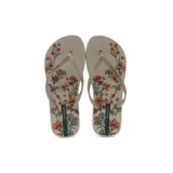 Ojotas Ipanema Oasis Fem color beige con estampado floral en tonos naranja y verde.