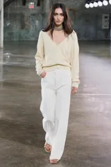 Cárdigan color crema de punto fino con escote en pico, cierre frontal con botones y manga larga.