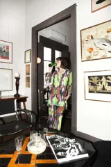 Pantalón largo de corte recto con estampado abstracto en tonos verde, marrón y negro.