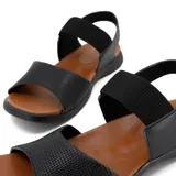 Sandalias bajas negras con elástico en el tobillo y capellada de cuero.