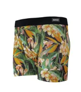 Boxer de lycra premium con estampado floral con hojas y flores tropicales en tonos amarillos, naranjas y verdes sobre fondo negro. Cintura elástica negra con logo Rufián.