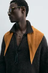 Sweater tipo polo color gris oscuro, de punto con textura, corte regular fit, cuello solapa con abertura frontal, manga larga y terminaciones en rib.