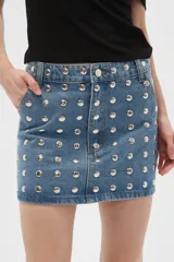 Minifalda de jean azul con tachas plateadas.