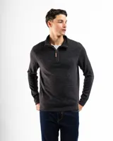 Sweater verde de punto con cuello alto y cierre medio con cremallera.