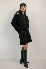 Bermuda negra con costuras blancas a contraste y diseño geométrico.