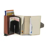 Billetera doble de cuero marrón con detalles en rosa. Cuenta con doble caja de aluminio con sistema de deslizamiento para tarjetas, clip para billetes y espacio adicional para documentos.