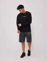 Sweater negro de corte regular con logo Rusty estampado en el pecho.