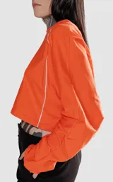 Remera corta naranja de manga larga con ribete blanco en las mangas.