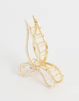 Broche dorado para el pelo con forma de moño, decorado con perlas.