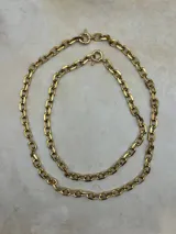 Collar de cadena dorada con eslabones rectangulares y cierre de aro tipo spring ring.
