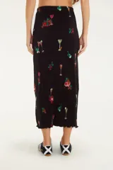 Falda midi plisada con estampado tropical de cócteles, cintura alta y corte clásico. Confeccionada en poliéster.