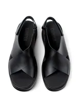 Sandalias negras de cuero vacuno con plataforma gruesa y tiras cruzadas.