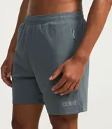 Bermuda deportiva masculina gris con cintura elástica, bolsillos laterales y cordón de ajuste.