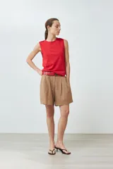 Musculosa roja de algodón con cuello redondo y botones decorativos en los hombros.