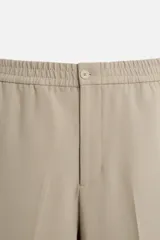 Pantalón negro de corte recto con cintura elástica, bolsillos laterales y un bolsillo trasero de ojal.