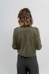 Chaqueta color beige de tela tipo gamuza con elastano, cuello solapa, manga larga con trabillas en hombro, bolsillos delanteros con cremallera metálica y cierre frontal con cremallera.