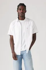 Camisa blanca a rayas verticales finas, de manga corta, con cuello clásico, cierre frontal con botones y un bolsillo en el pecho.