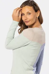 Buzo tejido de algodón con diseño combinado en bloques de color: beige en la parte superior, azul en la parte inferior izquierda y verde en la parte inferior derecha.