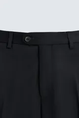 Pantalón de vestir negro de lana, corte recto, con bolsillos laterales y traseros de ojal con botón.