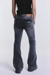 Pantalón de jean negro con tiro bajo y corte acampanado.