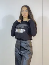 Remera negra de manga larga con estampado plateado y gris con la frase "Emotion Me".