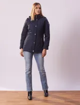 Campera capitoneada azul marino con capucha desmontable, cierre frontal con botones a presión y bolsillos laterales con cierre.