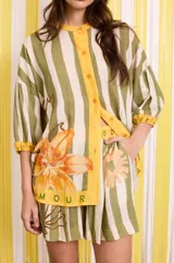 Short con estampado a rayas verticales en tonos verde y blanco, con cintura elastizada y detalle de estampado floral y texto.