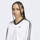 Remera Adidas Adicolor de manga larga, color blanco con cuello en V y logo bordado en el pecho. Presenta las tres tiras características de la marca en color negro a lo largo de las mangas.